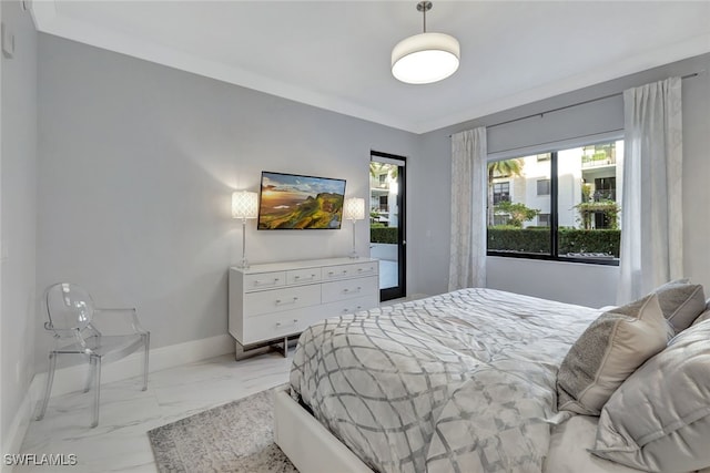 bedroom with ornamental molding and access to outside