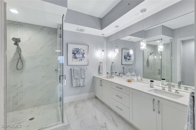 bathroom featuring a shower with door and vanity