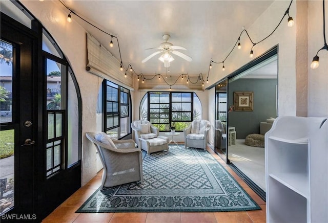 sunroom featuring ceiling fan and rail lighting