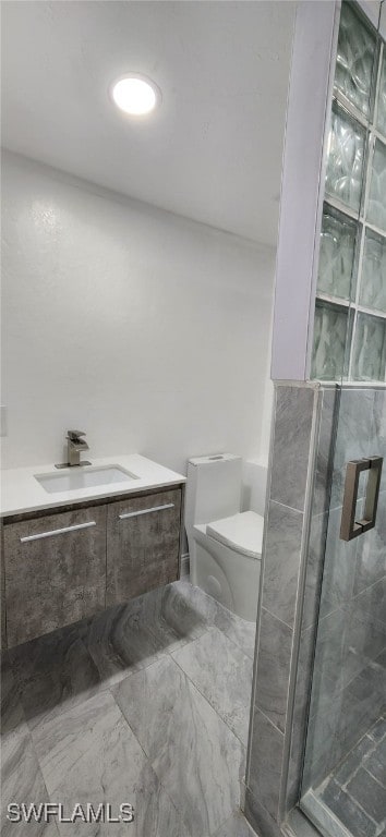 bathroom featuring toilet, walk in shower, and vanity