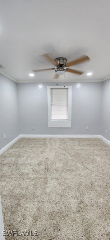 spare room with carpet, ceiling fan, and crown molding