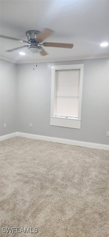 carpeted empty room featuring ceiling fan