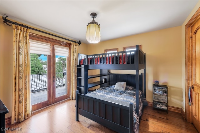 bedroom featuring access to exterior, french doors, and hardwood / wood-style flooring