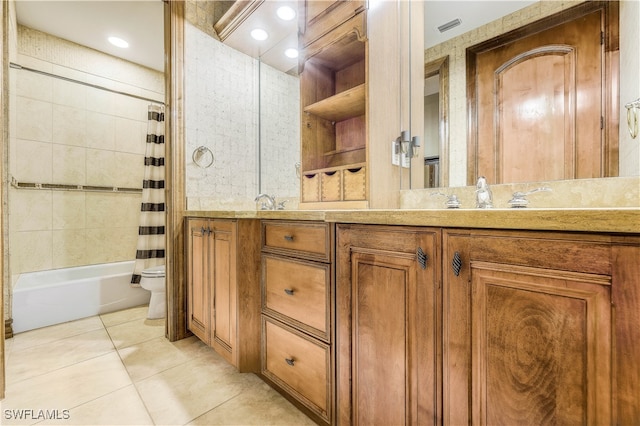 full bathroom with tile patterned flooring, vanity, shower / tub combo, and toilet