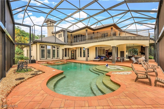 back of property featuring outdoor lounge area, a patio, a balcony, and a lanai