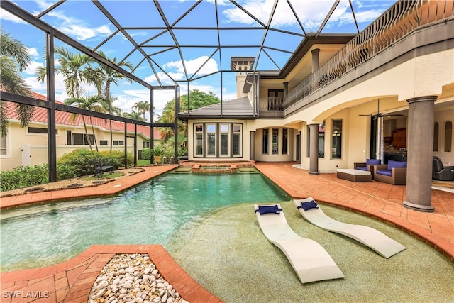 view of swimming pool featuring glass enclosure, ceiling fan, an in ground hot tub, and a patio