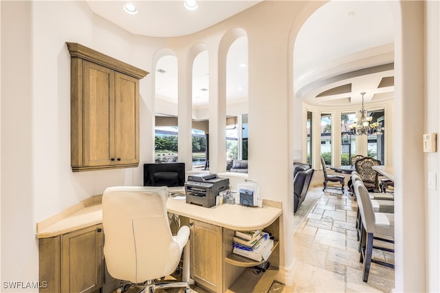 office space with a wealth of natural light and an inviting chandelier