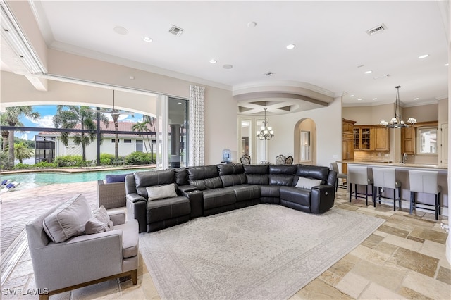 living room featuring ornamental molding and a chandelier