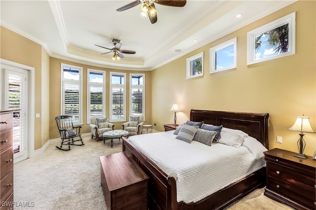 bedroom with light carpet, a tray ceiling, ceiling fan, and crown molding