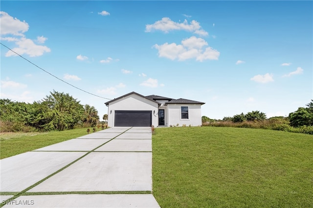 view of front of house featuring a front yard and a garage