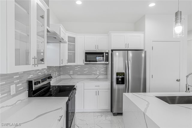 kitchen featuring light stone countertops, white cabinets, and appliances with stainless steel finishes