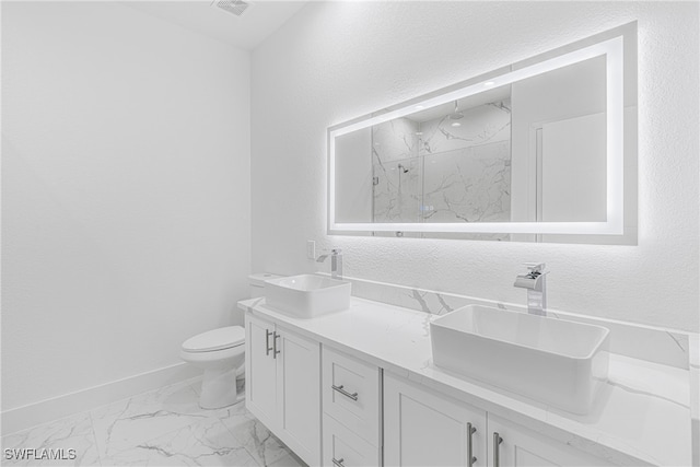 bathroom featuring a shower, vanity, and toilet