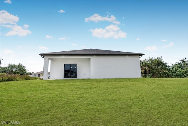 rear view of house with a yard