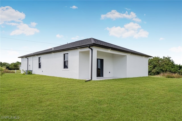 back of house with a lawn