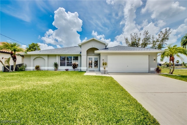 ranch-style home featuring french doors, a front lawn, and a garage