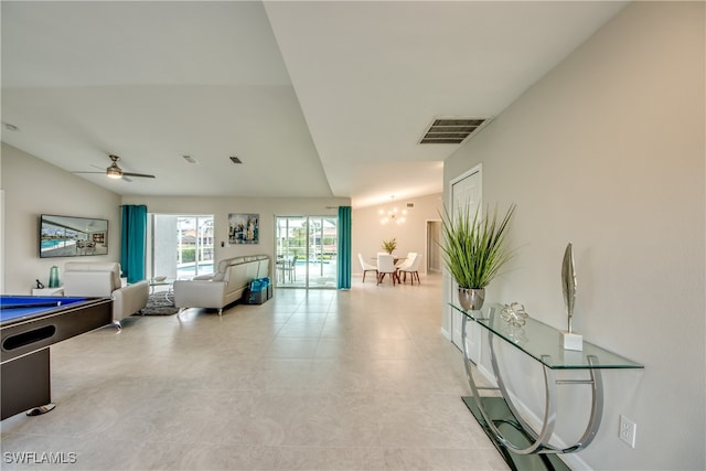 living room featuring ceiling fan and lofted ceiling