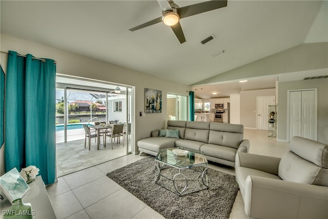 tiled living room featuring vaulted ceiling and ceiling fan