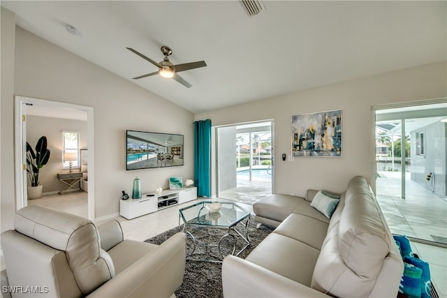 tiled living room with ceiling fan and lofted ceiling