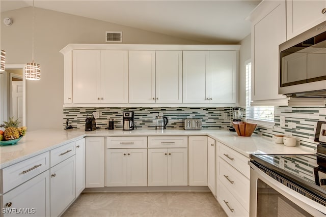 kitchen featuring white cabinetry, hanging light fixtures, lofted ceiling, and electric stove