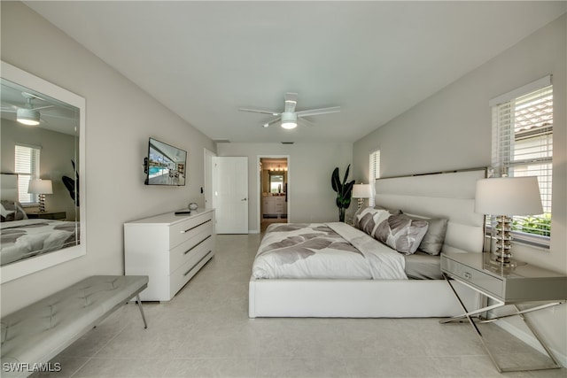 bedroom with multiple windows, ceiling fan, and light tile patterned floors