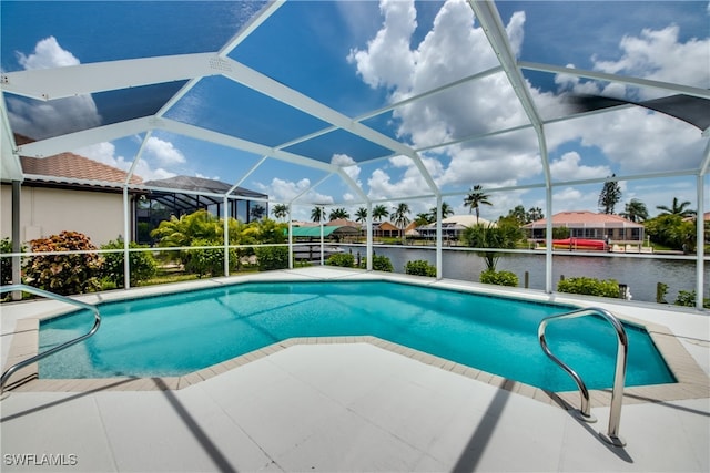 view of swimming pool with a lanai, a patio area, and a water view