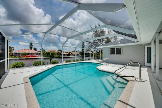 view of pool featuring a water view, glass enclosure, and a patio area