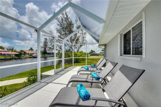 sunroom featuring a water view