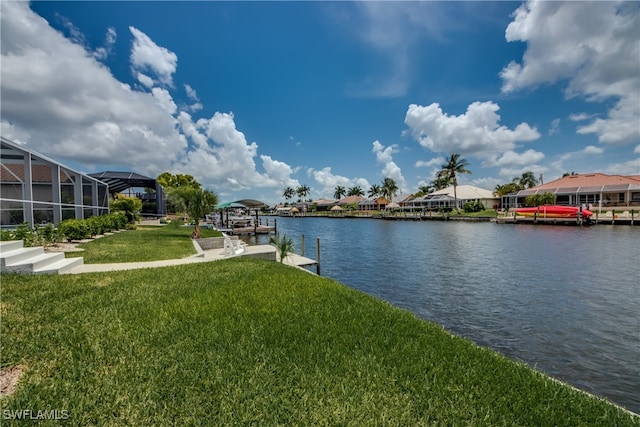 view of dock featuring a yard, a water view, and a lanai