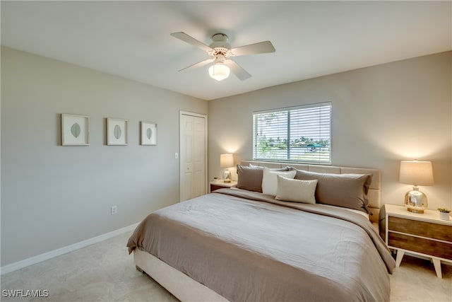 bedroom with light carpet, a closet, and ceiling fan