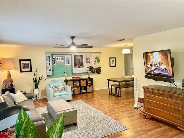 living room with ceiling fan and wood-type flooring