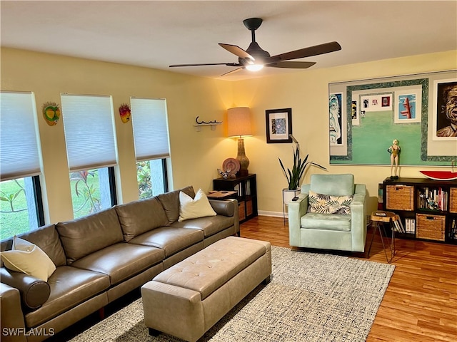 living room featuring ceiling fan and hardwood / wood-style floors