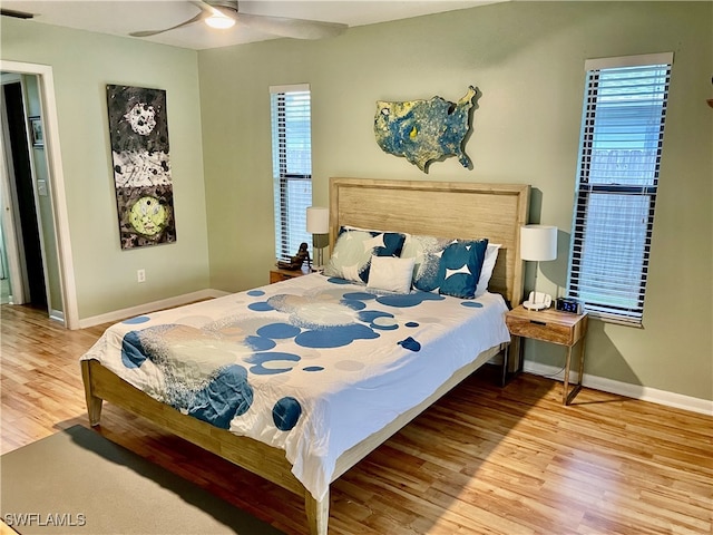 bedroom with ceiling fan and light hardwood / wood-style flooring