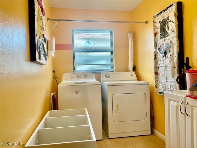 laundry room with light tile patterned floors, separate washer and dryer, and sink