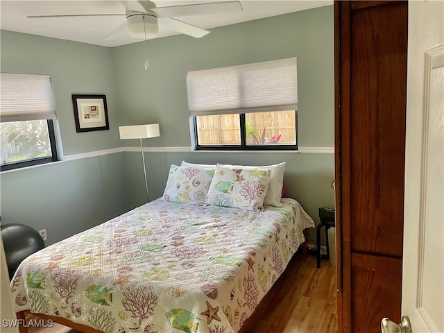 bedroom with hardwood / wood-style floors and ceiling fan