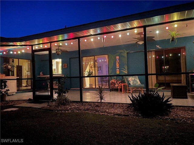 view of back house at twilight