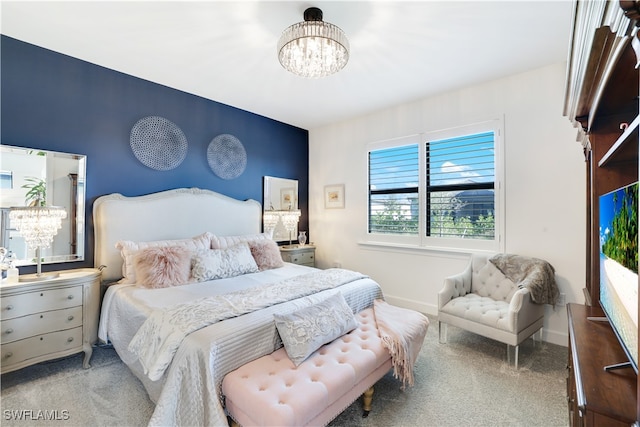 carpeted bedroom with an inviting chandelier