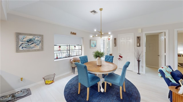 dining space with light hardwood / wood-style flooring, a notable chandelier, and crown molding