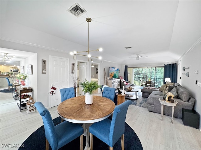 dining room with ceiling fan with notable chandelier, light hardwood / wood-style floors, and ornamental molding