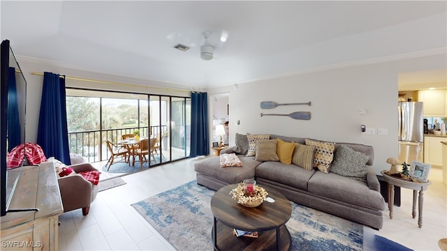 living room with ceiling fan and crown molding