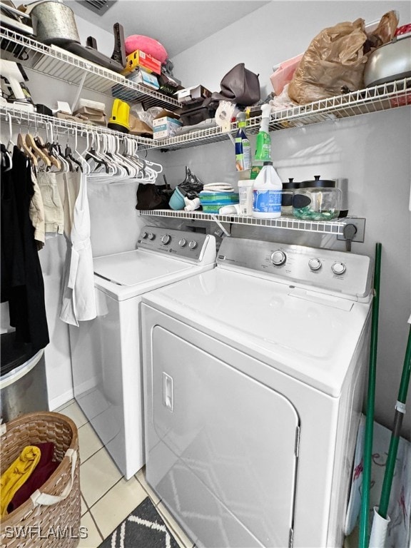 laundry area featuring separate washer and dryer and light tile patterned floors