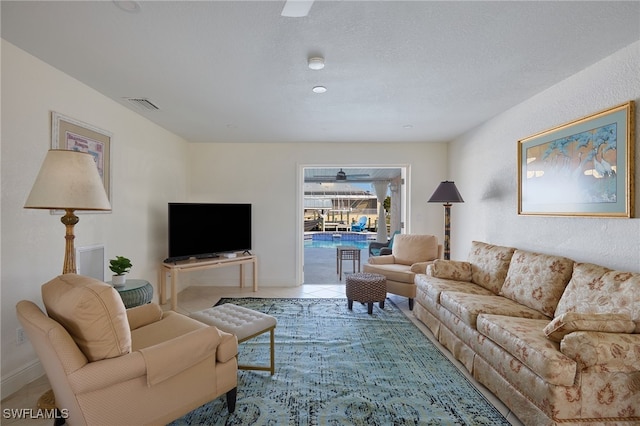 tiled living room with a textured ceiling