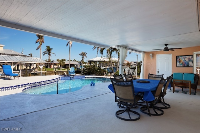 view of pool with ceiling fan and a patio