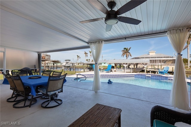 view of pool with a boat dock and a patio area