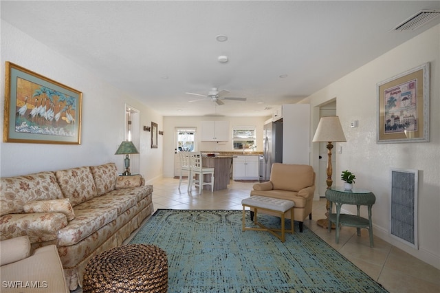 tiled living room featuring ceiling fan