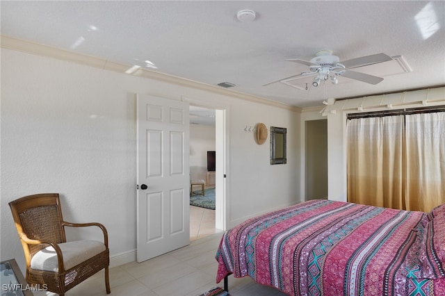 bedroom with ceiling fan, ornamental molding, and light tile patterned floors