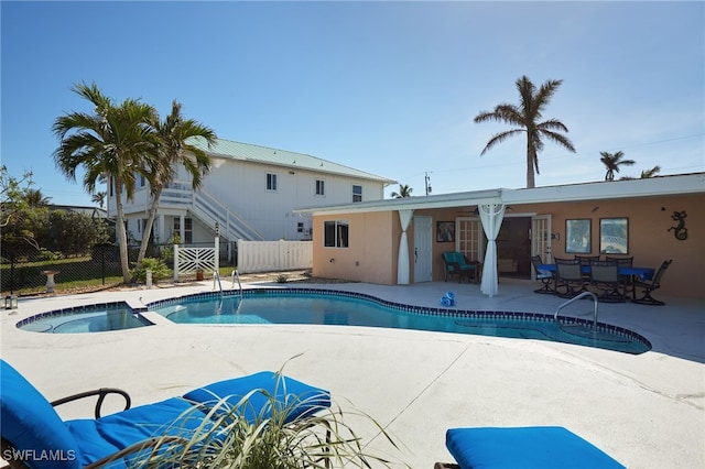 view of pool with an in ground hot tub and a patio