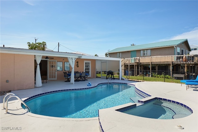 view of swimming pool with a patio area and an in ground hot tub