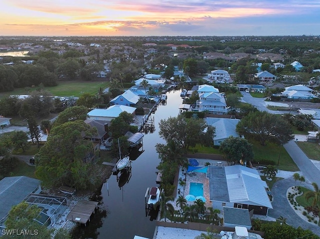 aerial view at dusk with a water view