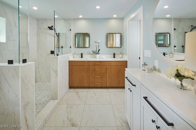 bathroom with tiled shower and vanity