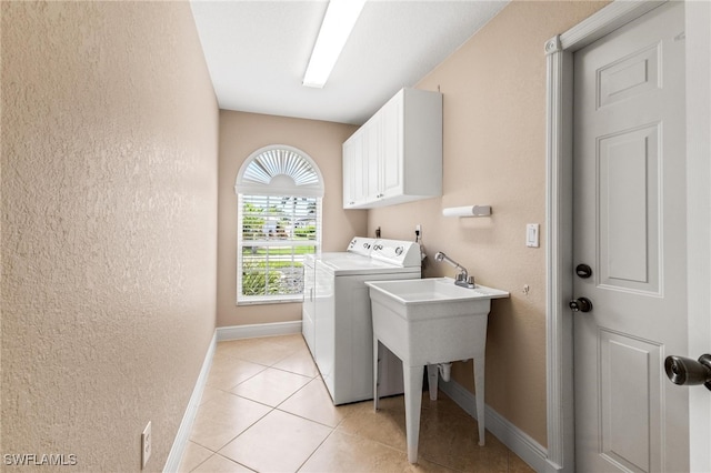 laundry room with light tile patterned floors and cabinets